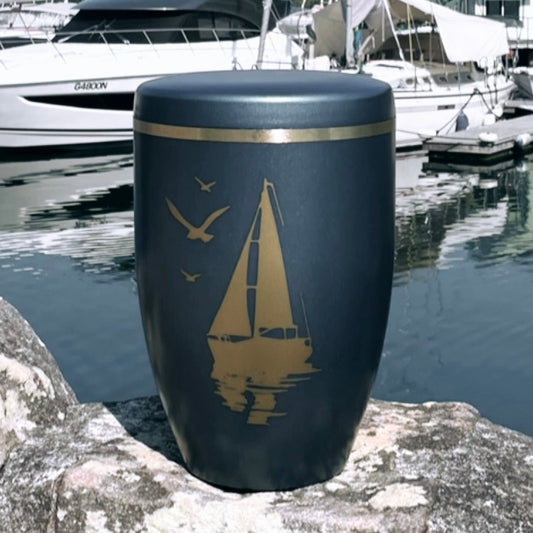 Stunning blue cremation urn with sailing ship in front of harbour background