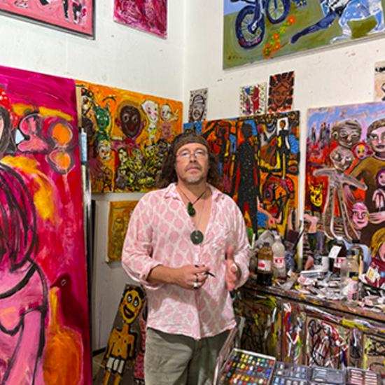The artist Carlos Barrios in his studio surrounded by his art.