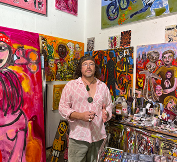 The artist Carlos Barrios in his studio surrounded by his art.