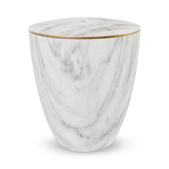 Beautiful marble imitation urn for ashes with a delicate gold ring.