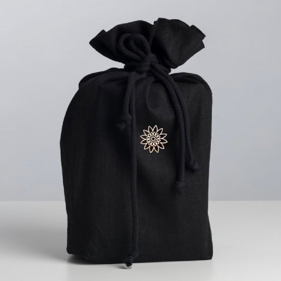 Simple and beautiful black fabric urn for ashes made of the finest ecological Italian linen and adorned with a delicate wooden ornament.