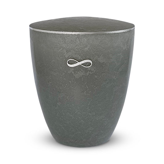 Very elegant silver grey cremation urn with a silver infinity symbol and delicate silver ring around the lid.
