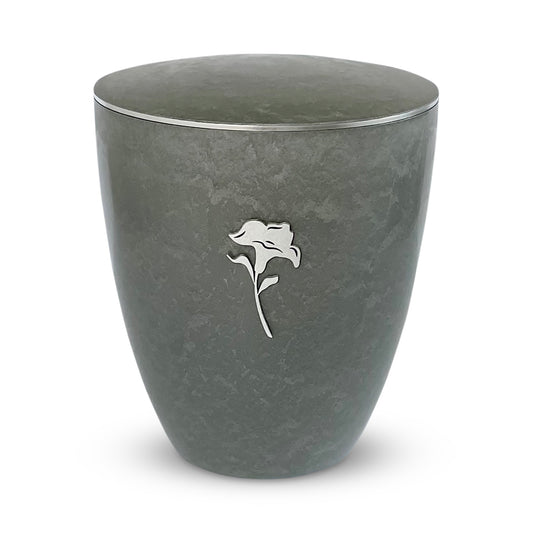 Beautiful silver grey urn for ashes with a silver lily and delicate silver band around the lid.