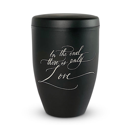 Black funeral urn engraved by hand with the wording 'In the end there is only Love'.